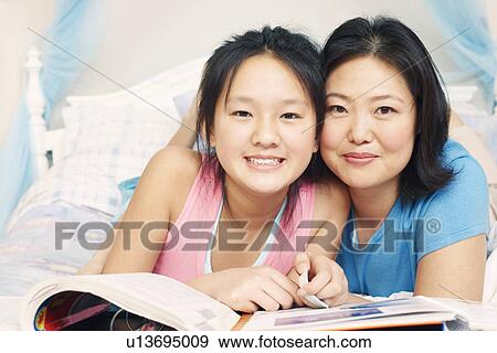 Portrait of a mother and her daughter smiling View Large Photo Image Stock Photo - Portrait of a mother and her daughter smiling. Fotosearch