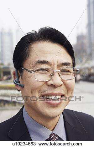 Close-up of a businessman smiling View Large Photo Image Stock Image - Close-up of a businessman smiling. Fotosearch