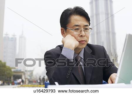 Stock Image - Close-up of a businessman using a laptop. Fotosearch