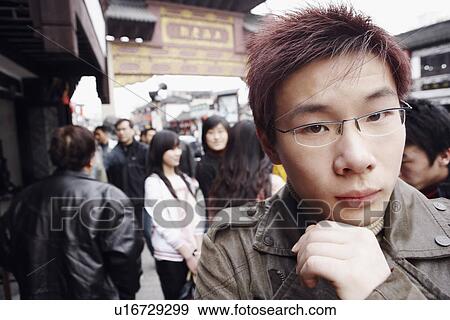 Stock Photo - Close-up of a young man thinking. Fotosearch