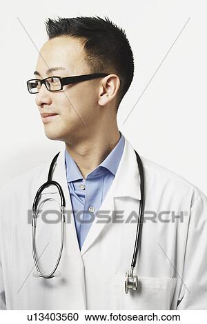 Stock Image - Male doctor with a stethoscope around his neck. Fotosearch