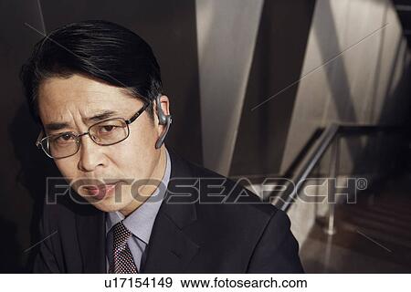 Portrait of a businessman looking serious View Large Photo Image Stock Photo - Portrait of a businessman looking serious. Fotosearch