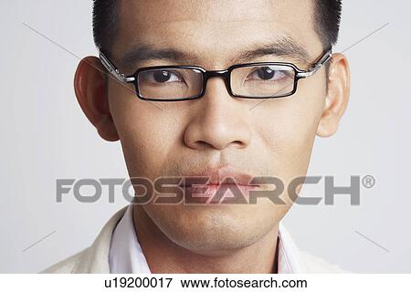 Stock Photo - Portrait of a businessman looking serious. Fotosearch
