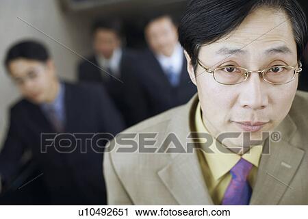 Stock Image - Portrait of a businessman on an escalator. Fotosearch