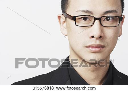 Portrait of a young man wearing eyeglasses View Large Photo Image Stock Photo - Portrait of a young man wearing eyeglasses. Fotosearch