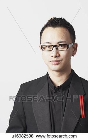 Stock Photo - Portrait of a young man with a pair of chopsticks in his pocket. Fotosearch