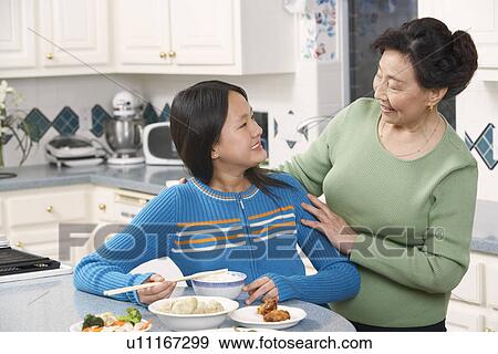 Stock Photo - Close-up of a girl and her grandmother. Fotosearch