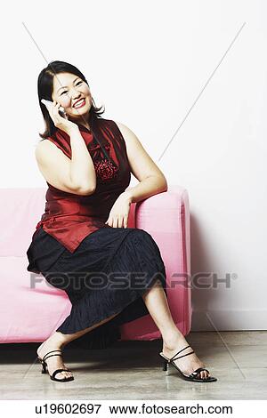 Mid adult woman talking on a mobile phone View Large Photo Image Stock Photo - Mid adult woman talking on a mobile phone. Fotosearch