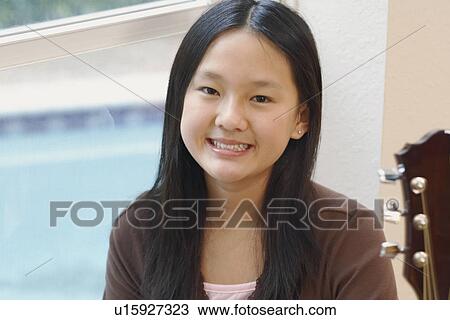 Stock Image - Portrait of a girl smiling. Fotosearch