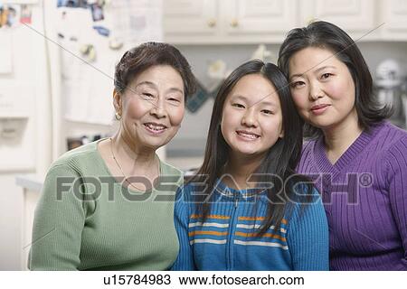 Stock Image - Portrait of a girl smiling with her mother and grandmother. Fotosearch