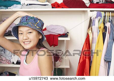 Stock Image - Portrait of a girl wearing a hat. Fotosearch