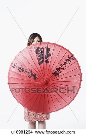 Portrait of a mid adult woman holding a parasol View Large Photo Image Picture - Portrait of a mid adult woman holding a parasol. Fotosearch