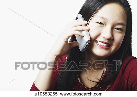 Portrait of a teenage girl talking on a mobile phone View Large Photo Image Stock Photography - Portrait of a teenage girl talking on a mobile phone. Fotosearch