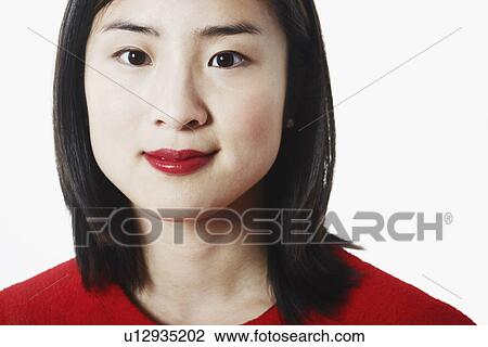Stock Image - Portrait of a young woman grinning. Fotosearch