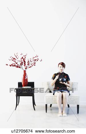 Portrait of a young woman holding a tea kettle View Large Photo Image Picture - Portrait of a young woman holding a tea kettle. Fotosearch