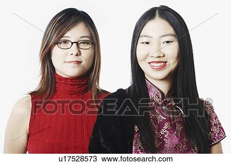 Stock Image - Portrait of two young women smiling. Fotosearch