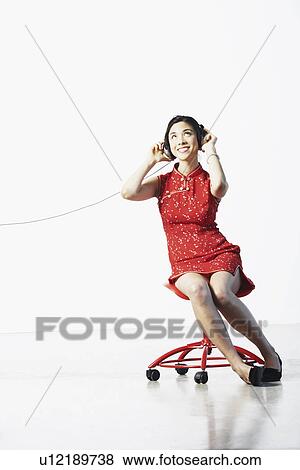 Young woman listening to music View Large Photo Image Stock Photo - Young woman listening to music. Fotosearch