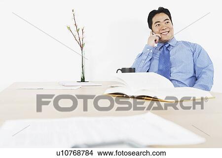 Picture - Businessman using a mobile phone. Fotosearch