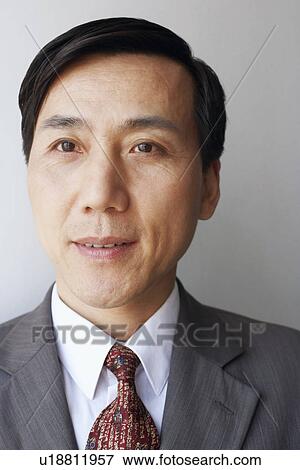 Stock Photo - Close-up of a businessman looking away. Fotosearch