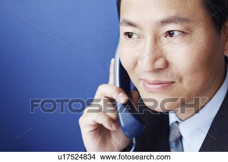 Picture - Close-up of a businessman talking on the telephone. Fotosearch