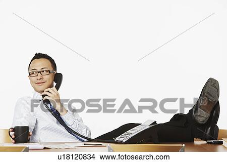Picture - Close-up of a businessman talking on the telephone. Fotosearch