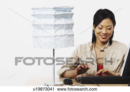Stock Image - Close-up of a businesswoman using a computer. Fotosearch