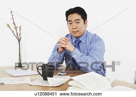 Stock Image - Portrait of a businessman sitting. Fotosearch