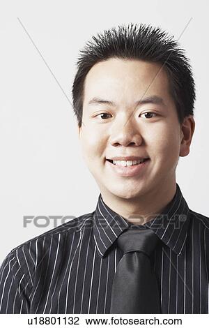 Portrait of a businessman smiling View Large Photo Image Stock Image - Portrait of a businessman smiling. Fotosearch