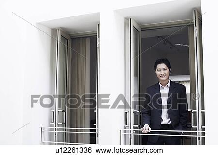 Portrait of a businessman smiling View Large Photo Image Stock Photograph - Portrait of a businessman smiling. Fotosearch
