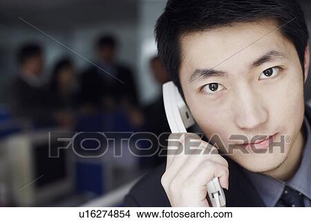 Picture - Portrait of a businessman talking on the telephone. Fotosearch