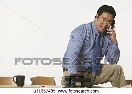 Stock Photography - Portrait of a businessman using the telephone. Fotosearch