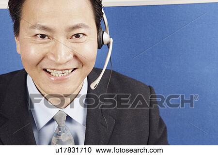 Portrait of a businessman wearing a headset View Large Photo Image Stock Image - Portrait of a businessman wearing a headset. Fotosearch