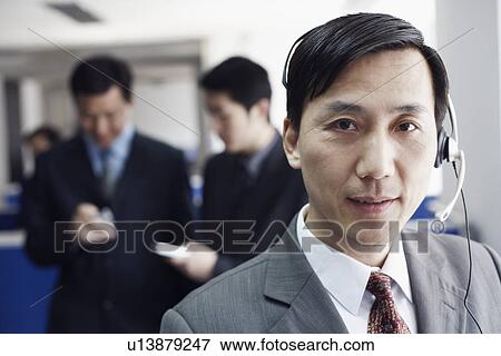 Portrait of a businessman wearing a headset View Large Photo Image Stock Photo - Portrait of a businessman wearing a headset. Fotosearch