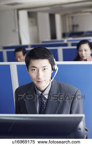 Stock Photography - Portrait of a businessman wearing a headset. Fotosearch