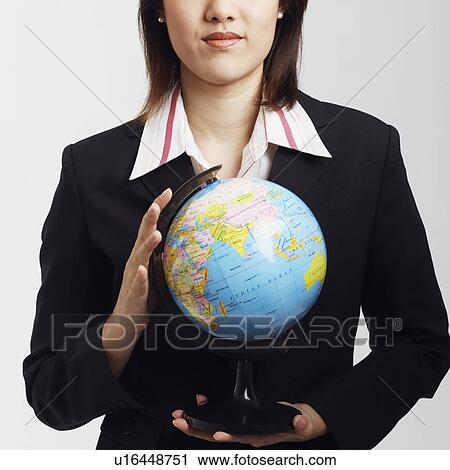 Portrait of a businesswoman holding a globe View Large Photo Image Stock Image - Portrait of a businesswoman holding a globe. Fotosearch