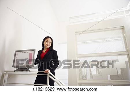 Portrait of a businesswoman showing a growth chart and smiling View Large Photo Image Stock Photo - Portrait of a businesswoman showing a growth chart and smiling. Fotosearch