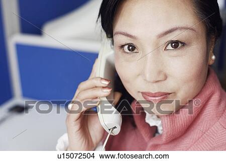 Picture - Portrait of a businesswoman talking on the telephone. Fotosearch