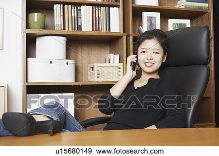 Portrait of a businesswoman using a mobile phone smiling View Large Photo Image Stock Photo - Portrait of a businesswoman using a mobile phone smiling. Fotosearch