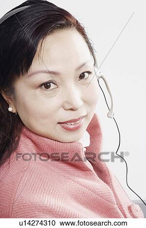 Portrait of a mature woman wearing a headset View Large Photo Image Stock Image - Portrait of a mature woman wearing a headset. Fotosearch