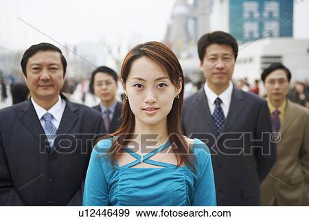 Portrait of a young woman standing with four businessmen View Large Photo Image Stock Photo - Portrait of a young woman standing with four businessmen. Fotosearch
