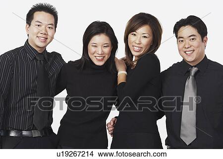 Picture - Portrait of two businessmen and two businesswomen smiling. Fotosearch