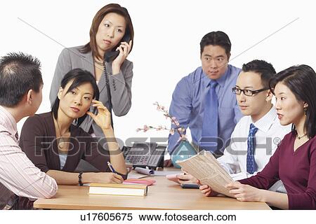 Stock Photography - Three businessmen and three businesswomen in a meeting. Fotosearch