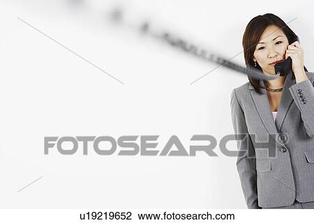 Businesswoman talking on the telephone View Large Photo Image Stock Image - Businesswoman talking on the telephone. Fotosearch