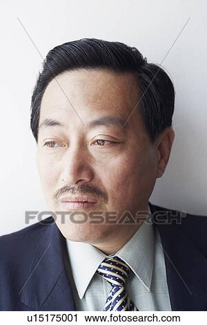 Stock Image - Close-up of a businessman looking away. Fotosearch