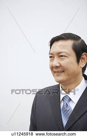 Stock Photo - Close-up of a businessman smiling. Fotosearch