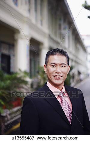 Stock Photo - Portrait of a businessman smiling. Fotosearch