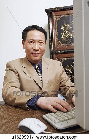 Stock Photo - Portrait of a businessman using a computer. Fotosearch