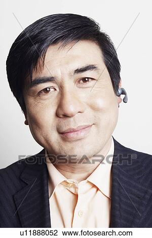 Portrait of a businessman wearing a hands free device smiling View Large Photo Image Stock Image - Portrait of a businessman wearing a hands free device smiling. Fotosearch
