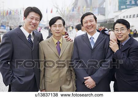 Portrait of four businessmen standing together View Large Photo Image Stock Photo - Portrait of four businessmen standing together. Fotosearch
