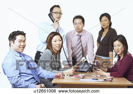 Portrait of three businessmen and three businesswomen in a meeting View Large Photo Image Stock Photo - Portrait of three businessmen and three businesswomen in a meeting. Fotosearch